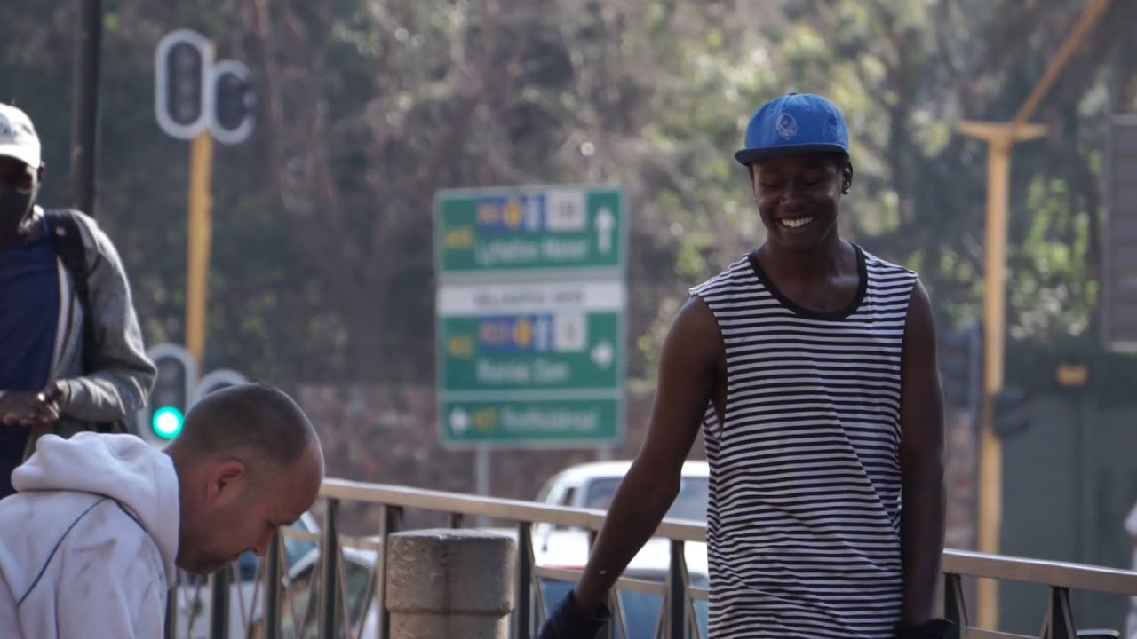 "Change" | A young man tries different ways to grab people's attention and get money at the traffic light.